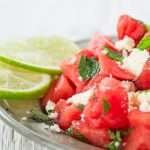 watermelon salad with cheese with lime on the side on the glass plate