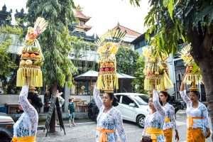Balinese women bring offering in front of bali direct store pererenan